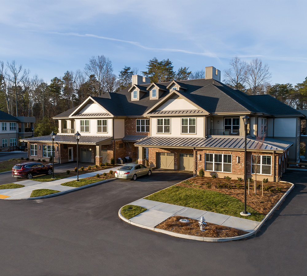 Exterior view of a modern senior living community building with multiple units.