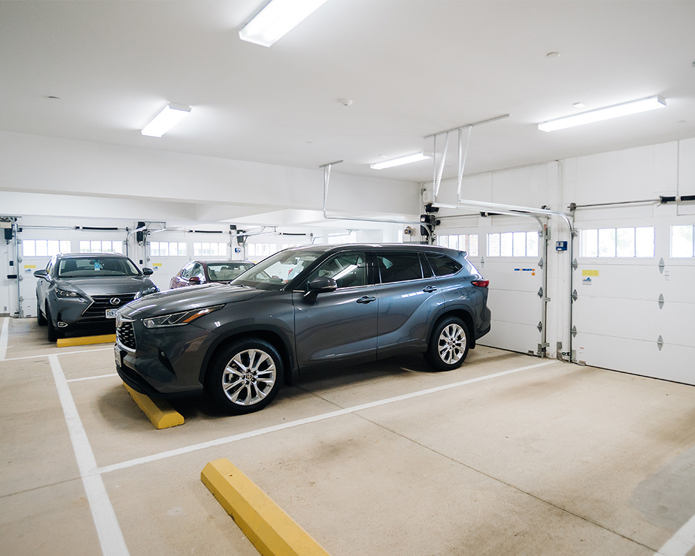Garage with parked vehicles in a senior living community.