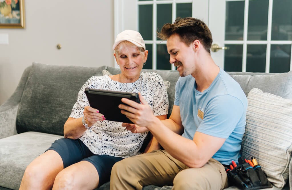 Senior woman learning how to use an iPad