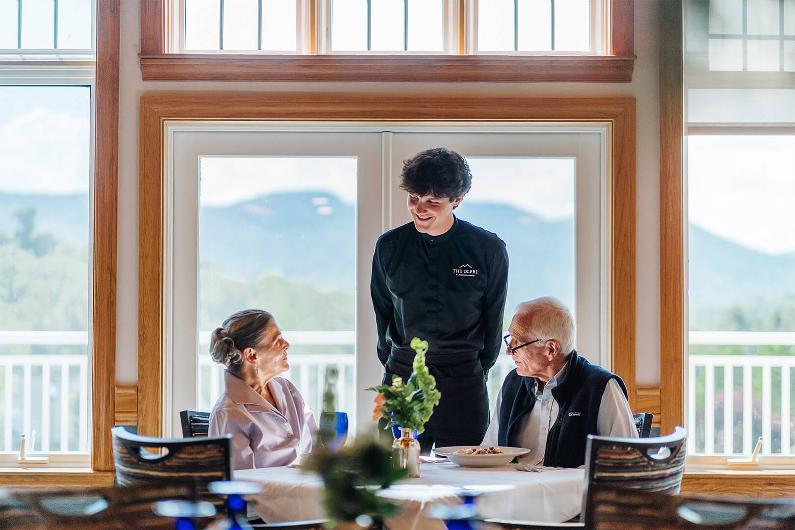 Young man serving senior residents of The Glebe