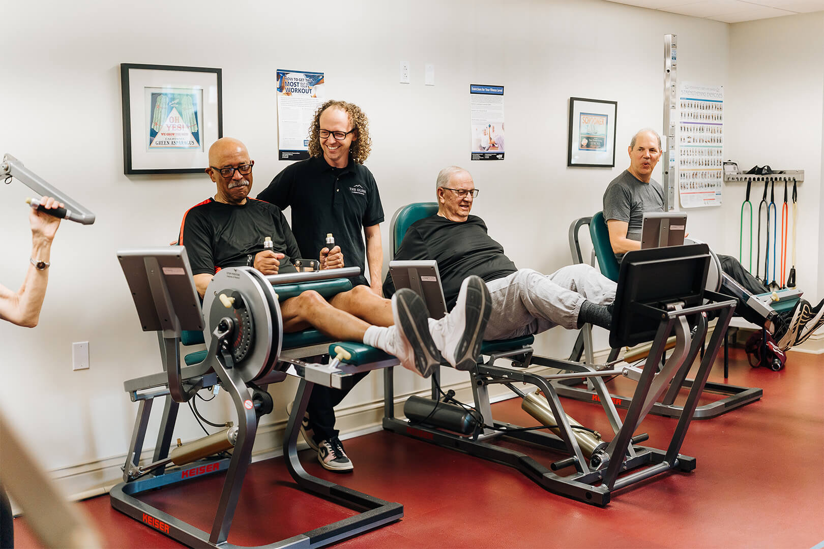 Residents participating in a fitness with equipment in a senior community gym.