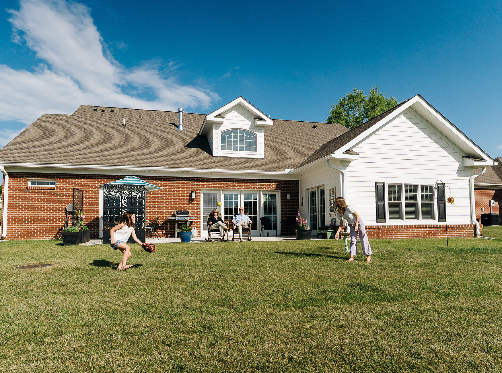 Grandkids playing catch in the backyard