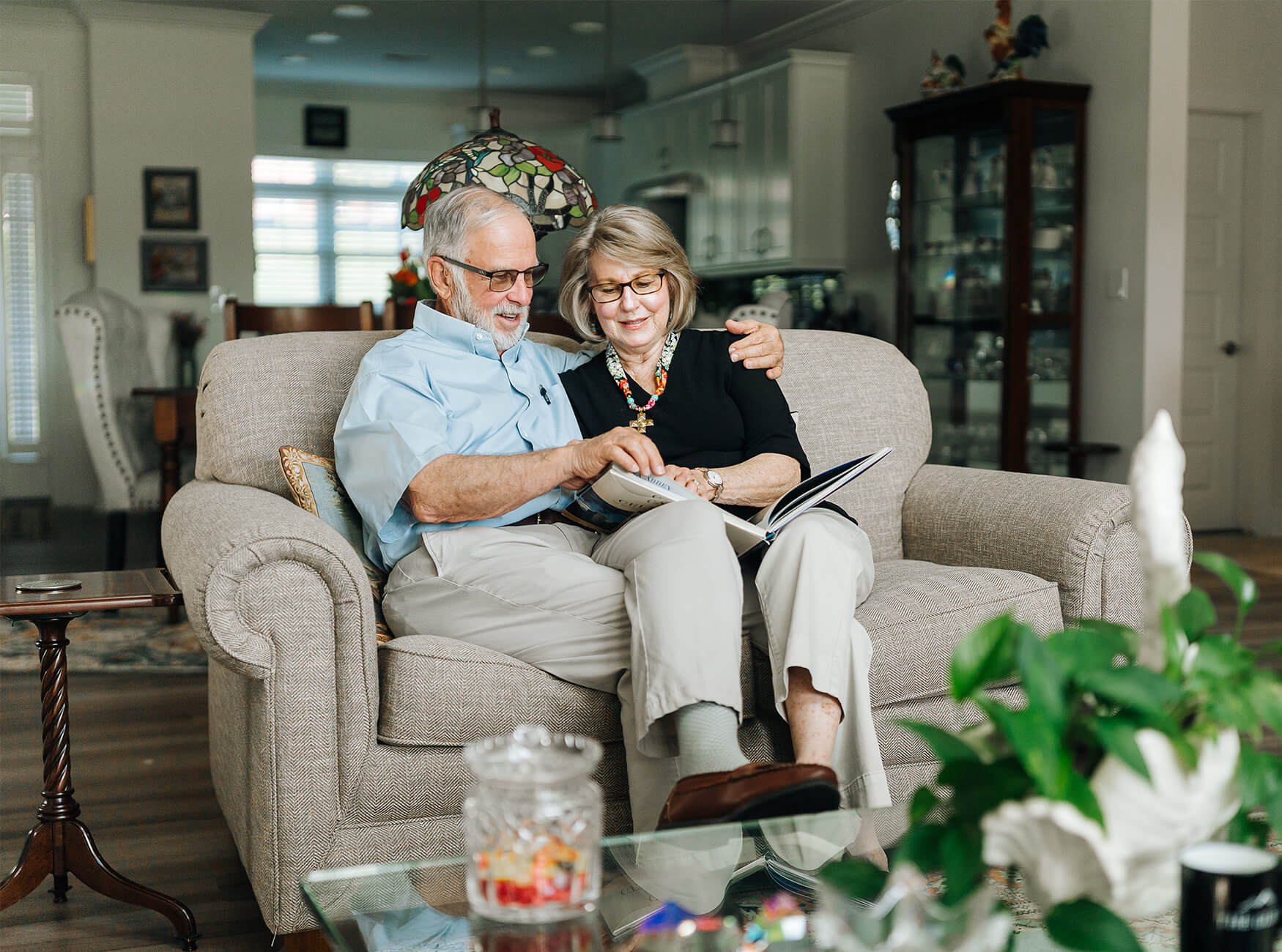 Senior couple smiling at photo album