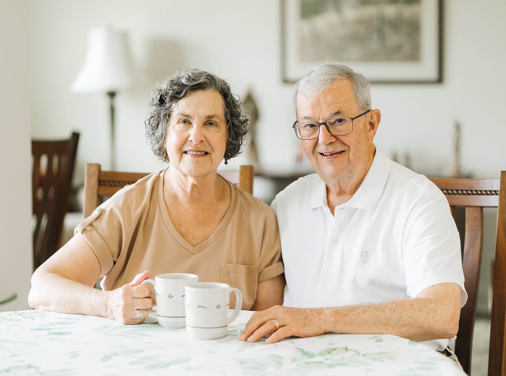 happy senior coupld sitting together at dining table