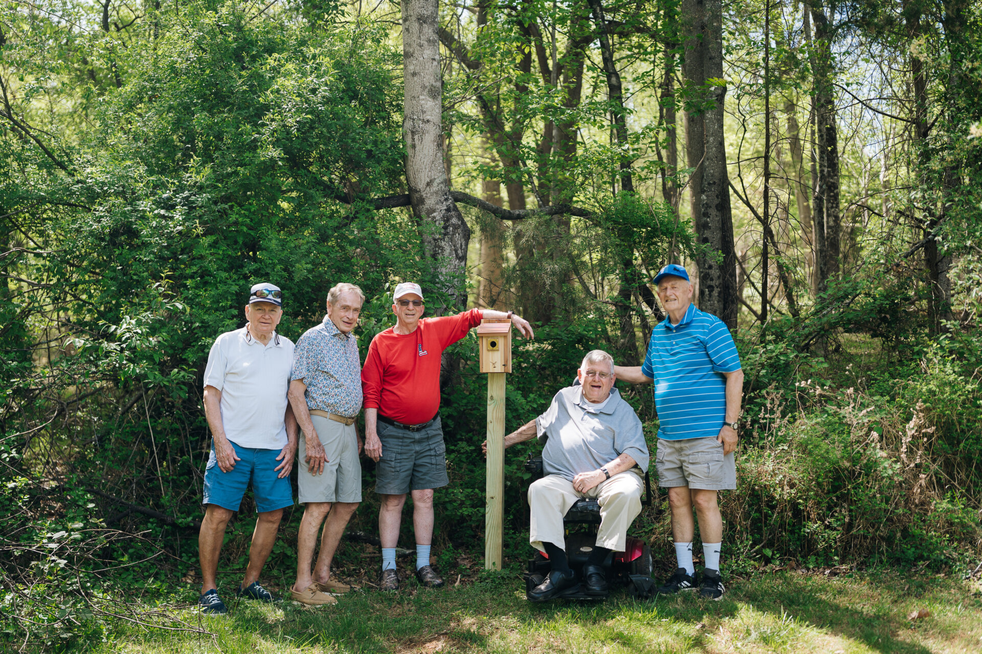 group of men posing with their birdhouse