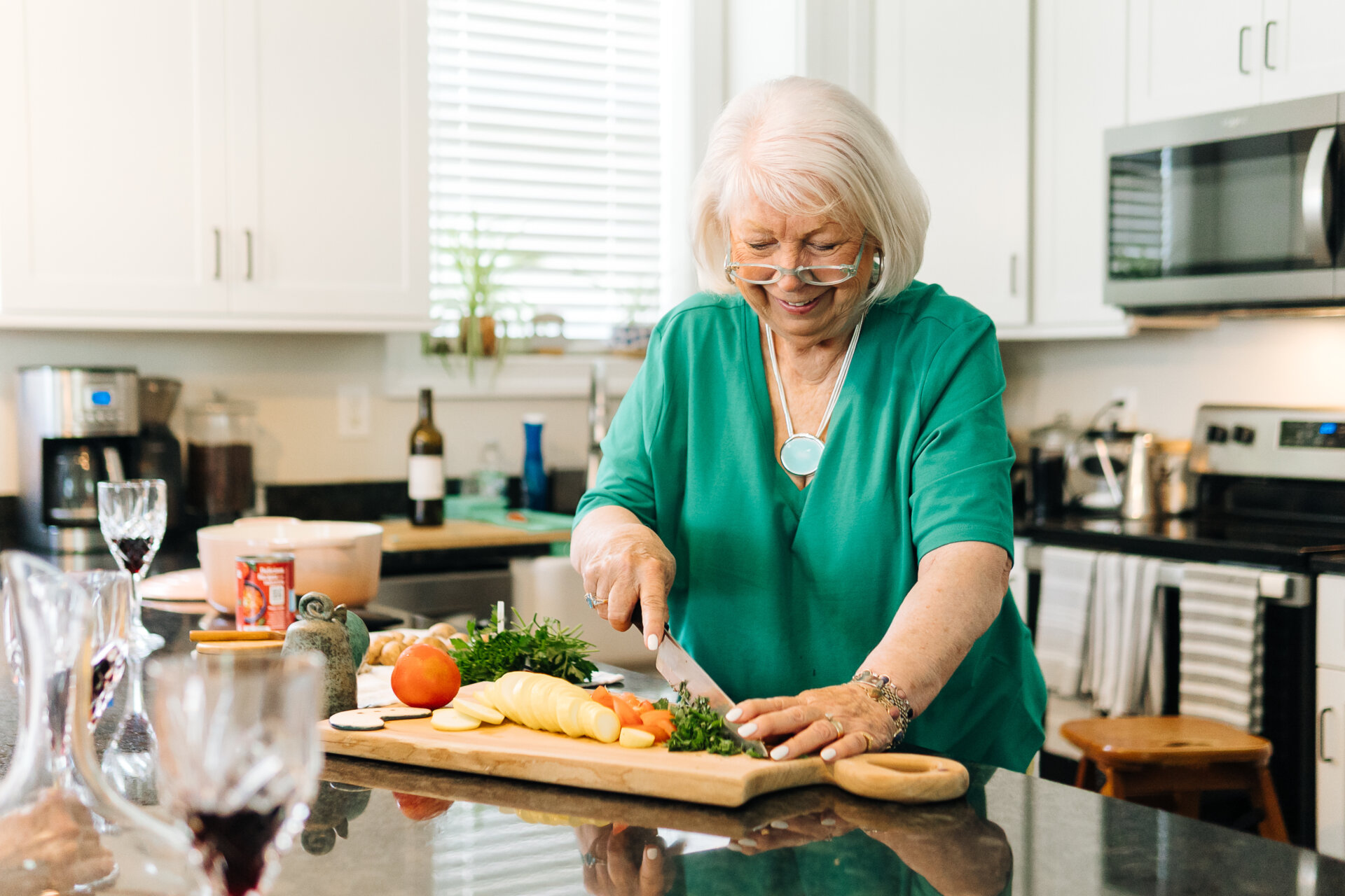 Senior woman preparing food in her kitchen