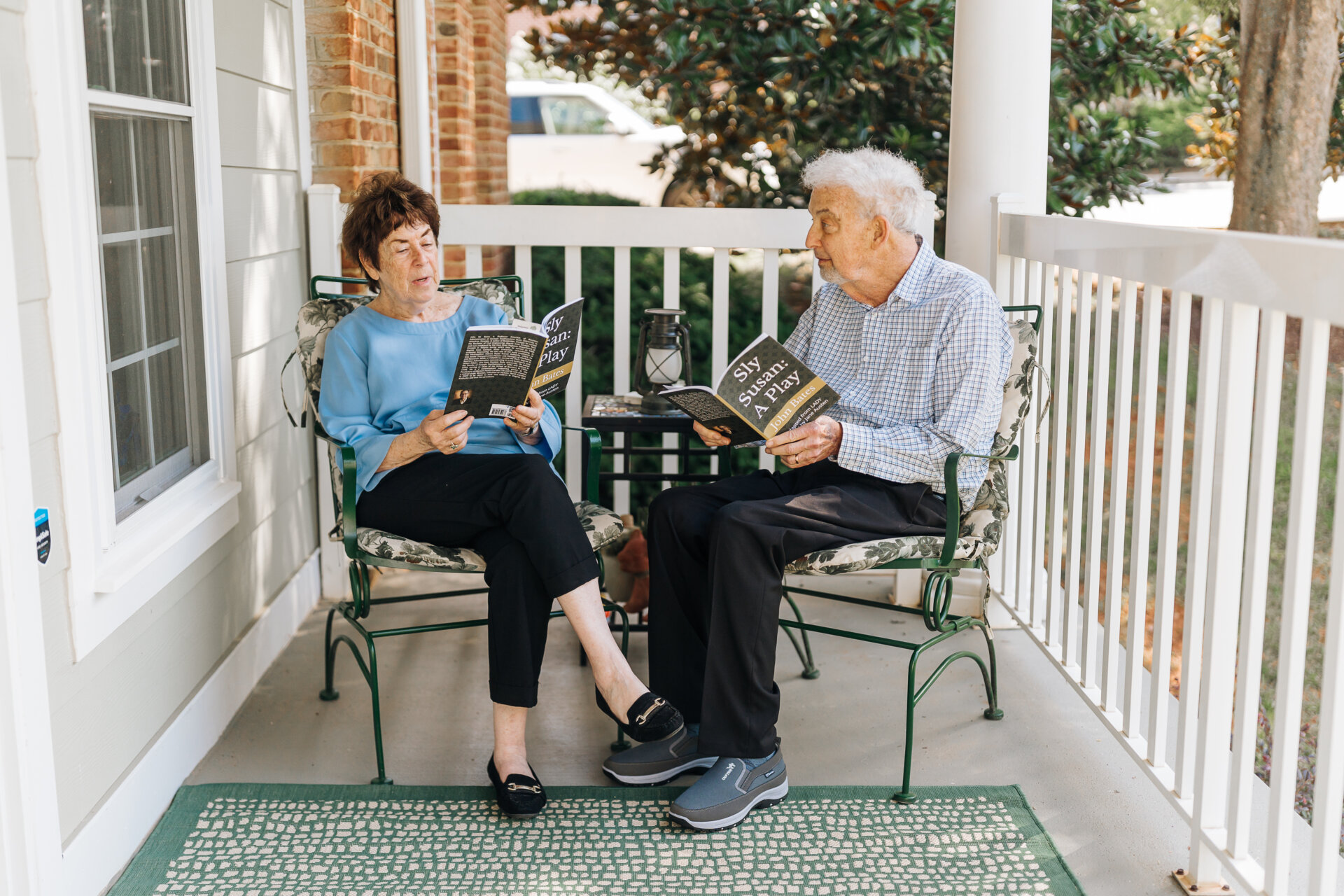 Senior couple reading on their front porch