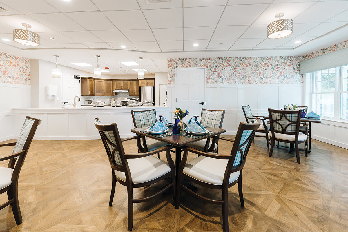 Elegant dining area with wooden tables in a residential community.